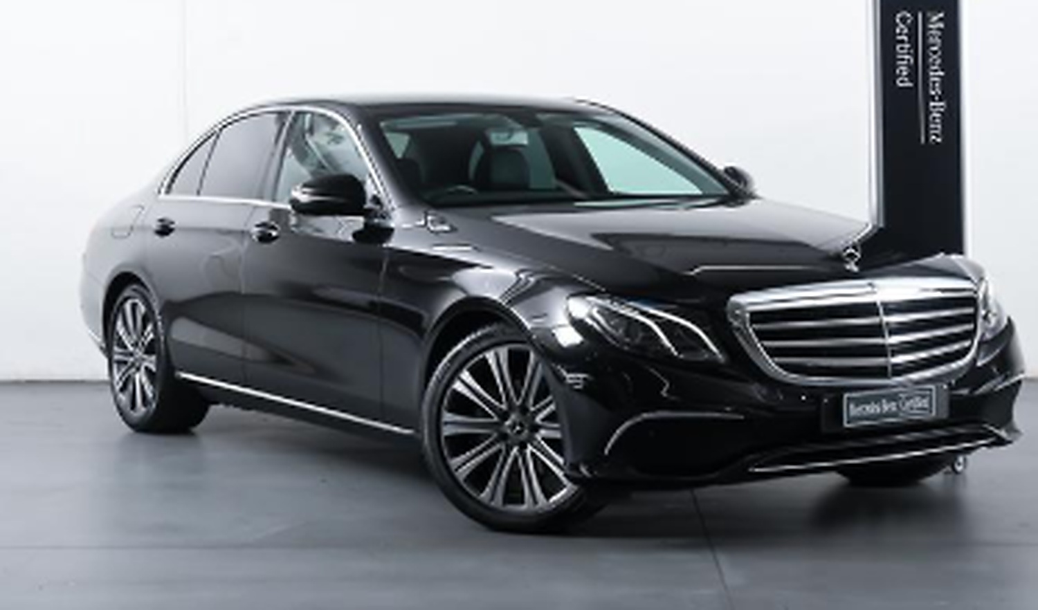 Black Mercedes E-Class Limousine Edition photographed at a Mercedes-Benz dealership